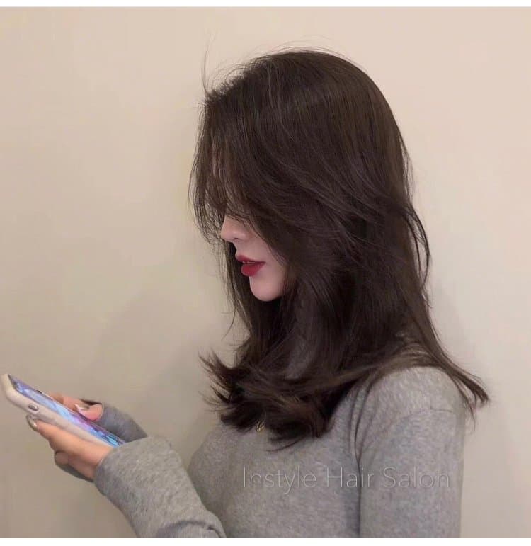 Dark layered mid-length cut with soft movement